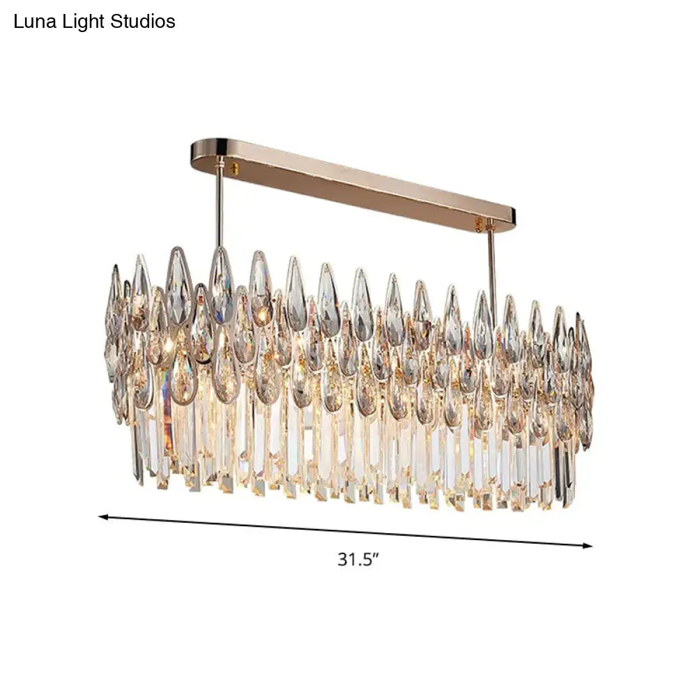 Modern rose gold crystal island lamp with rectangular metal frame and oval clear teardrop prisms for dining room pendant