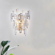 Modern rose gold wall lamp with asymmetrical clear crystal rectangles and warm center light for dining room use