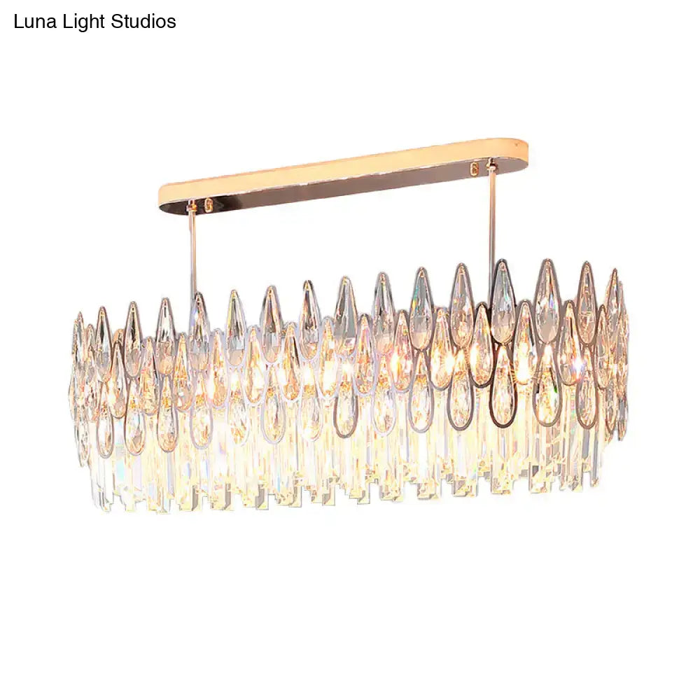 A modern rose gold island lighting chandelier with cascading clear and iridescent crystal tiers for kitchens
