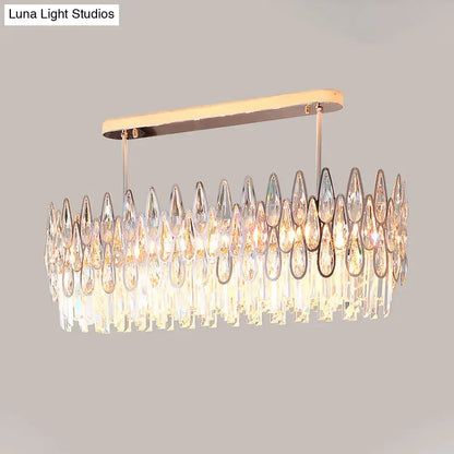 A modern rose gold island lighting chandelier with a rectangular metal frame and cascading crystal tiers for kitchens