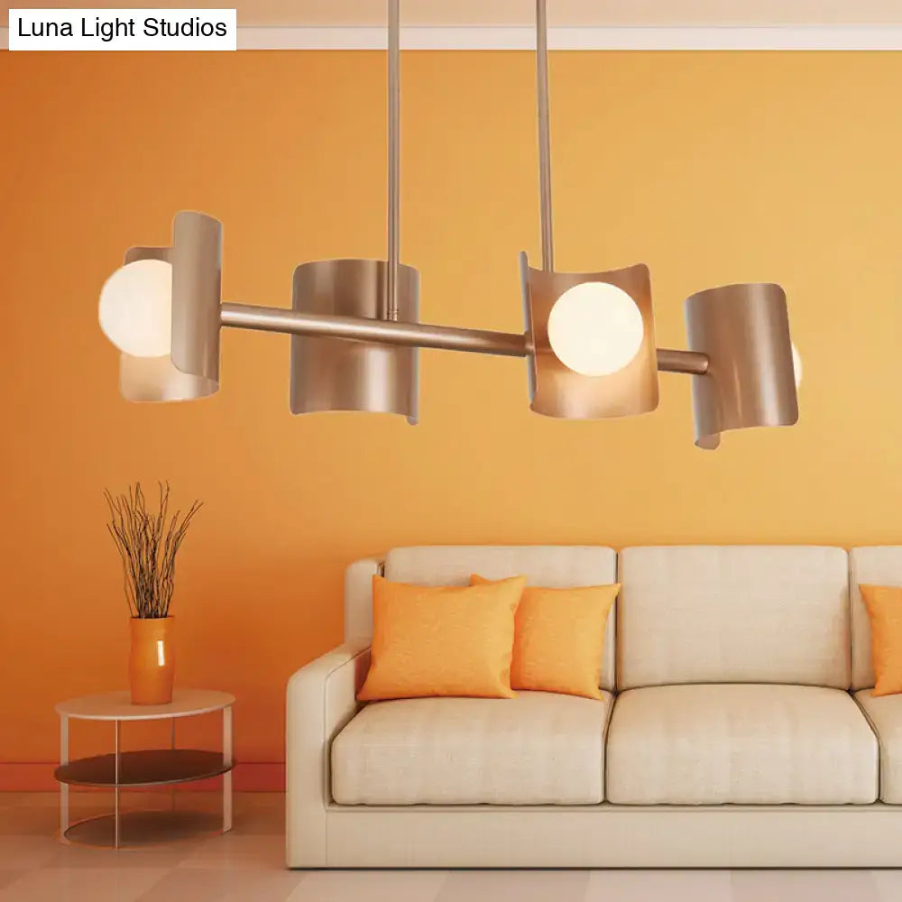 Modern rose gold pendant light with brushed nickel chandelier and four cylindrical shades for dining room use