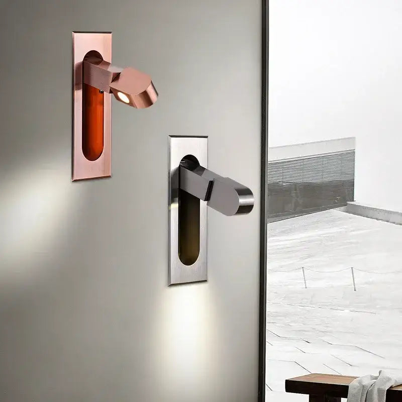 Two modern led wall lamps with articulated arms in rose gold and brushed stainless steel for bedroom reading light