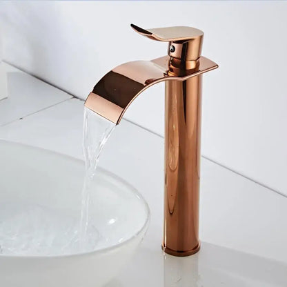 Modern rose gold single hole basin faucet with polished metallic housing material and sleek waterfall design