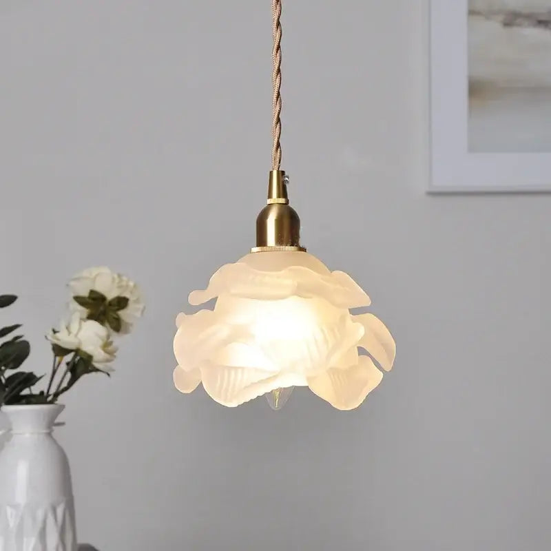 Modern rose orange and creamy white glass led pendant light with a translucent flower-shaped design and twisted beige cord