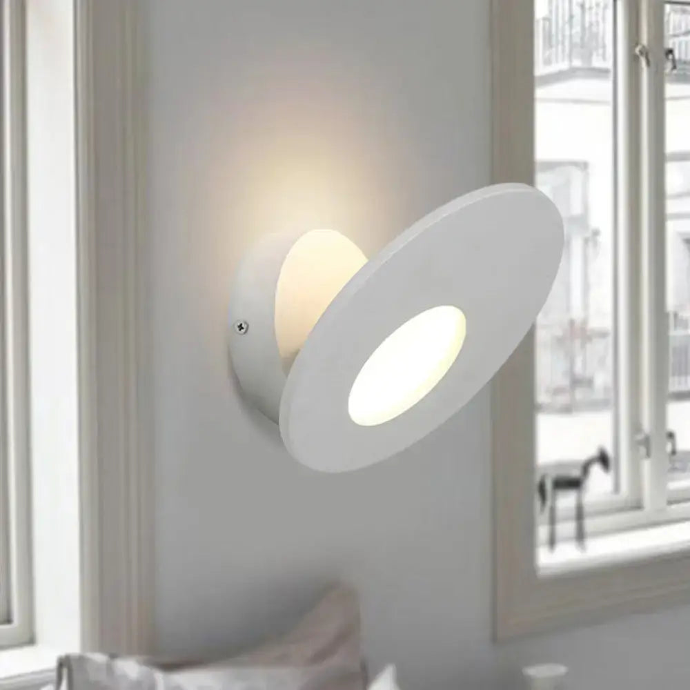 Modern round acrylic integrated led wall lamp in black and white with a sleek circular white adjustable wall lamp design