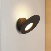 Modern black round acrylic wall lamp with integrated led and sleek circular design for bedroom lighting