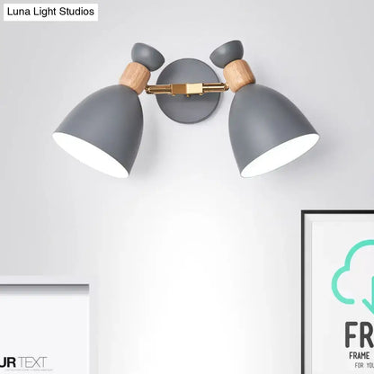 Modern sage green and gray double shade wall sconce with gray matte finish wooden accents and brass hardware inches high