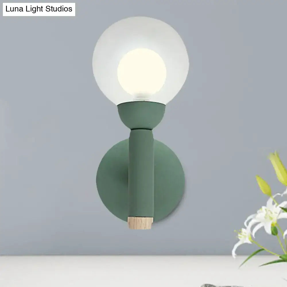 Modern sage green macaron style torch wall light with frosted glass globe and wooden accent for bedroom sconce lighting