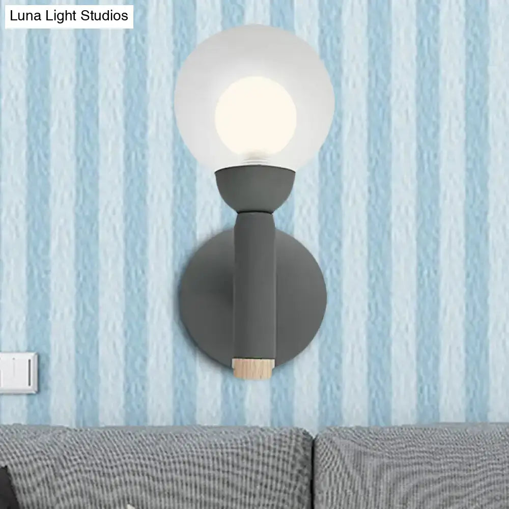Modern sage green macaron style torch wall light with grey white frosted glass globe and wooden accent for bedroom sconce