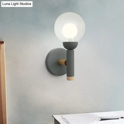 Modern gray wall light with frosted glass globe and wooden accents in macaron style torch design for bedroom use