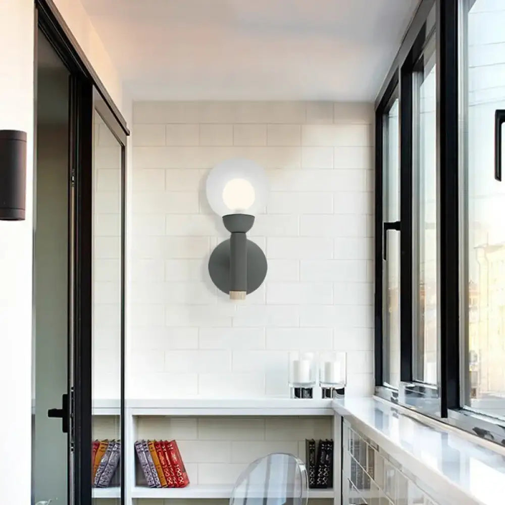 Modern grey white wall light featuring a macaron style torch design with frosted glass globe and matte finish for bedroom use