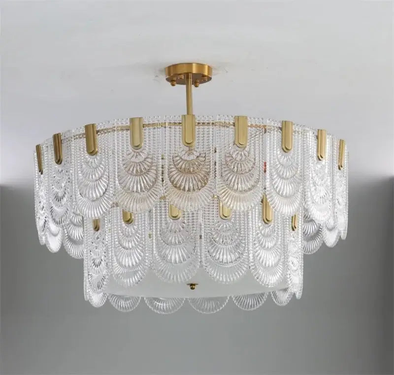 Modern scalloped art glass chandelier with clear glass shades and gold-toned metal accents for dining room decorbites art glass