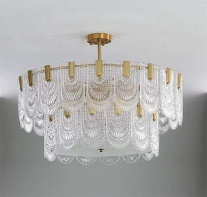 Modern scalloped art glass chandelier with clear glass shades and gold-toned metal accents for dining room decorbites art glass