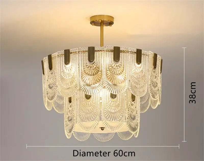 A modern scalloped gold dining room glass chandelier with a gold-toned metal frame and decorbites art glass tiers