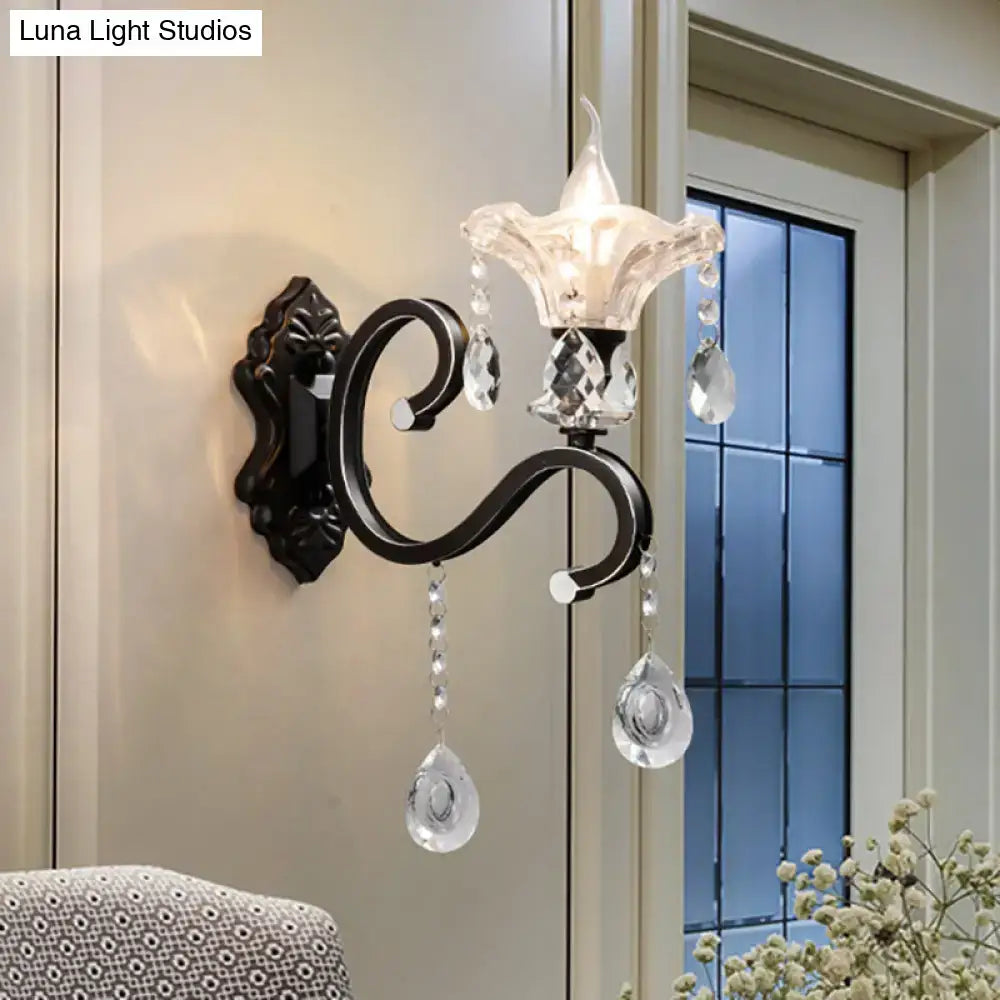Elegant black wrought iron wall lamp with curved arm featuring clear crystal droplets and a faceted glass shade, e12 e14 compatible