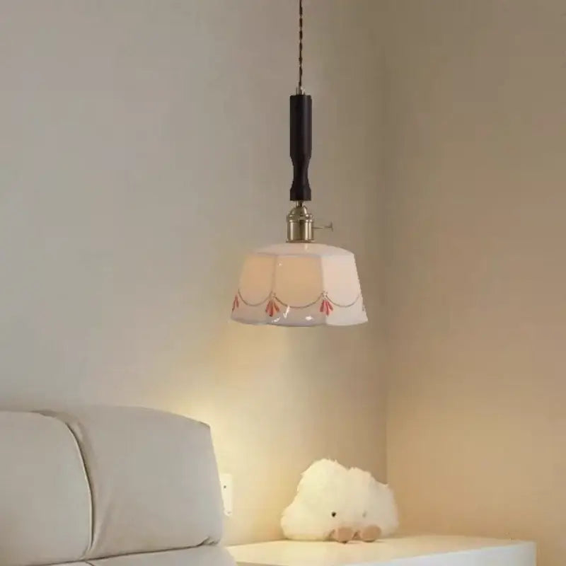 White octagonal ceramic led pendant light with red floral decorbites ceramic led patterns and dark wooden suspension rod