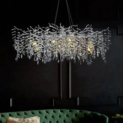 A modern silver and black crystal chrome chandelier with intricate branch design and leaf-shaped crystals for living room light