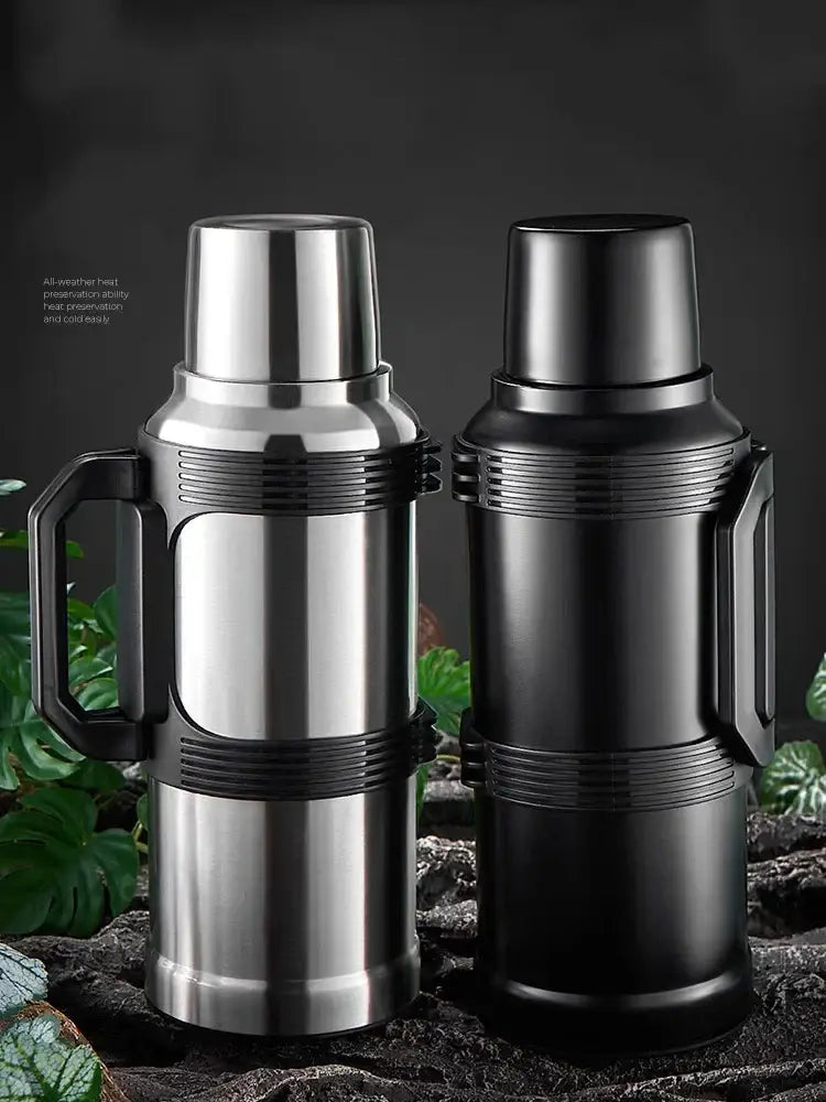 Modern silver and black insulated kettle with glass liner stainless steel thermos featuring textured grip and folding handle