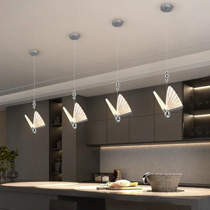 Modern silver butterfly led chandelier pendant light with sleek metal frames and translucent glass wings for dining room decorbites