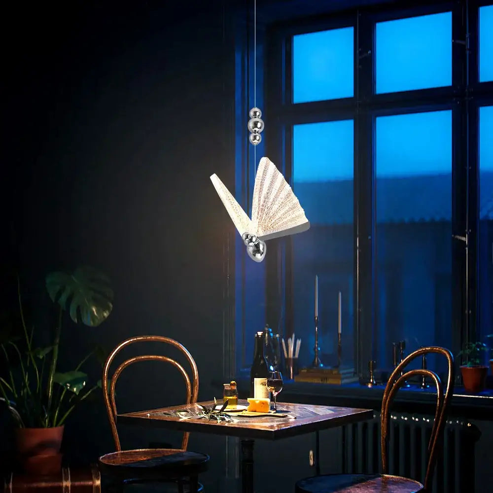 Modern silver butterfly led pendant light with textured fan-like wings and metallic finish for living room decorbites butterfly led