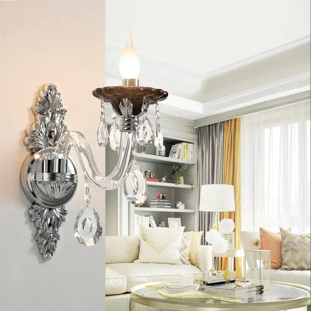 Modern silver candle wall mounted sconce with chrome finish dark brown ceramic base and dangling crystal droplets