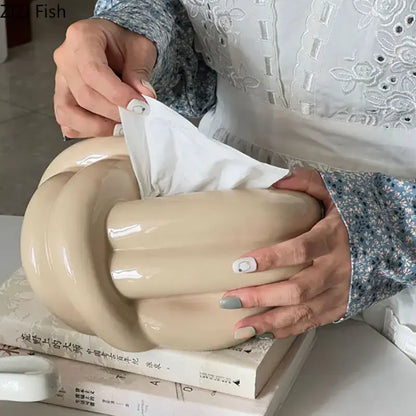 Modern silver ceramic knot tissue box in cream color with glossy finish and sculpted intertwined knot decorbites ceramic knot design