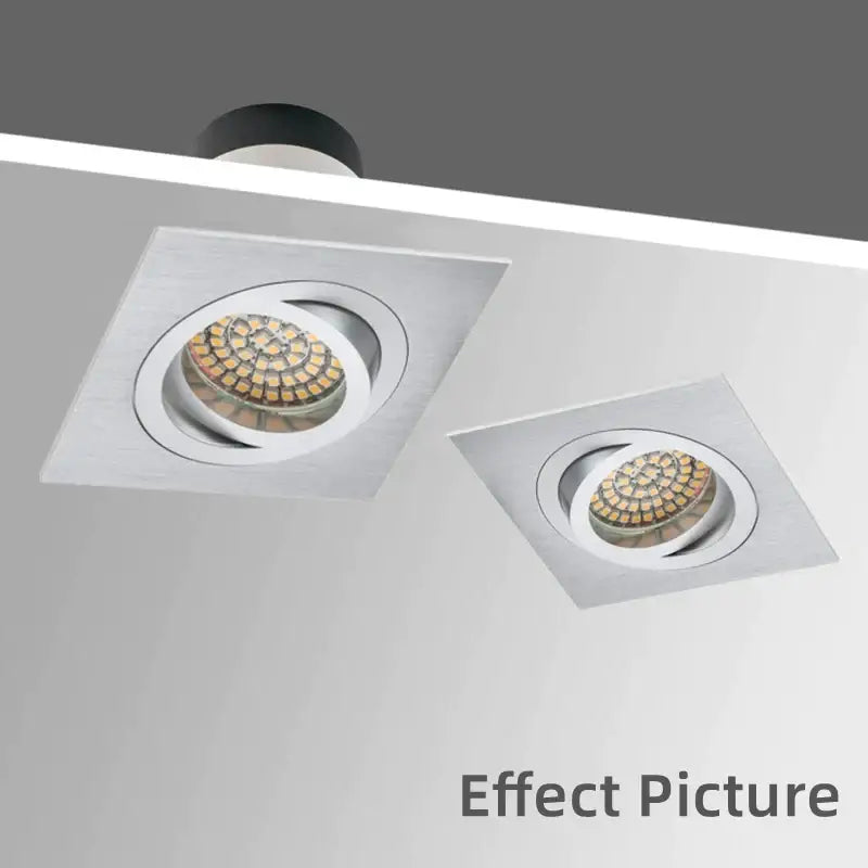 Two sleek modern silver and chrome square ceiling downlight frames with brushed metallic finish and circular led arrays
