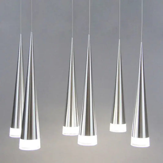 Six sleek silver decorbites conical pendant lights with frosted glass bases hanging in a modern dining room arrangement