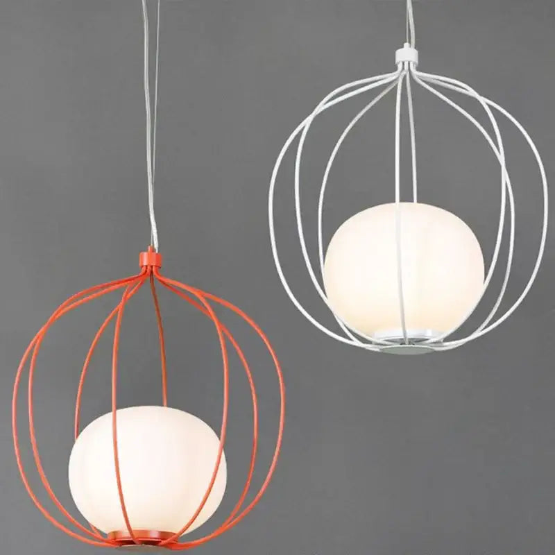 Modern silver and copper birdcage pendant light featuring two spherical frosted glass globes with orange and white wire cages
