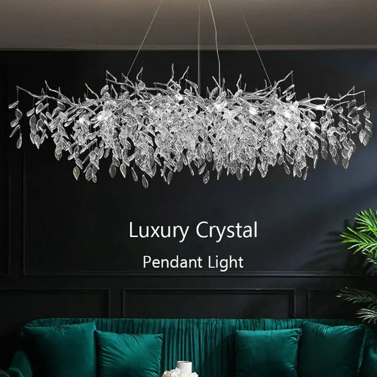 Modern silver crystal pendant light with shimmering leaf design resembling delicate transparent branches for dining room