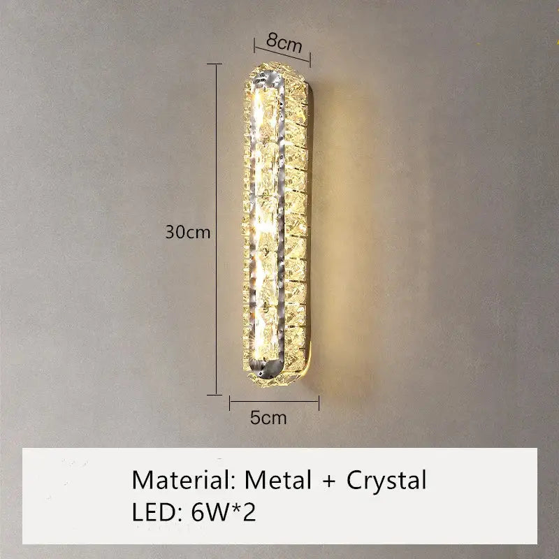 Modern silver crystal led wall lamp with metallic frame and decorbites crystal led embellishments emitting warm glow