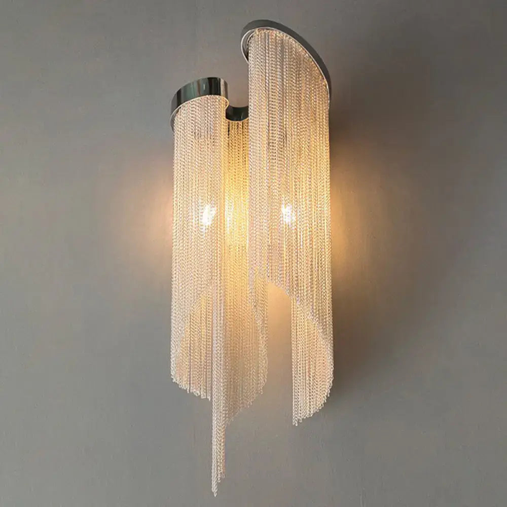 Modern silver crystal tassel wall light with cascading clear beads and curved chrome fixture for living room wall light