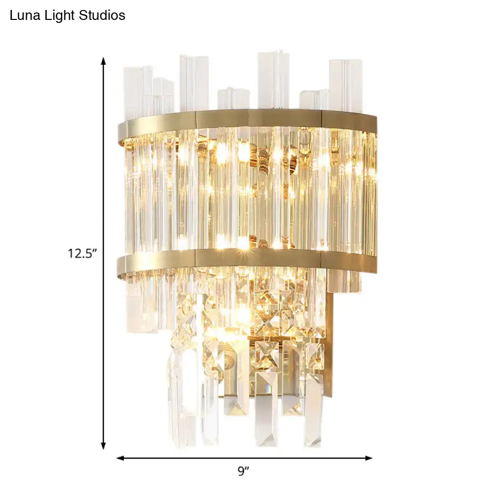 Modern gold-toned wall mounted wall light with cascading clear crystal rods and tiered horizontal bands for dining room fixture width