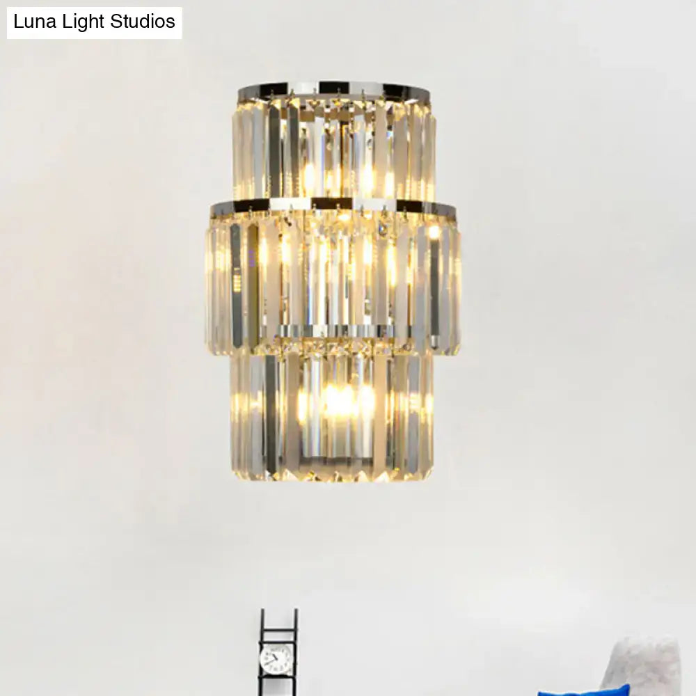 Modern silver crystal three-tiered wall mounted light with polished chrome accents and warm glowing lights
