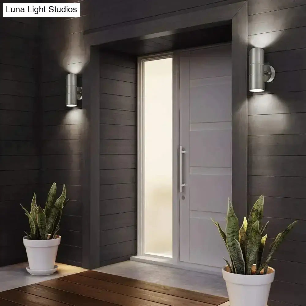 Modern silver cylindrical wall sconces made of metal with a sleek minimalist design for outdoor lighting