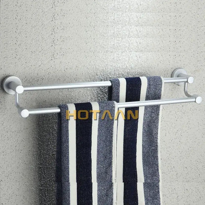 Modern silver double towel bar bathroom rack holding navy and white striped towels for organized towel storage