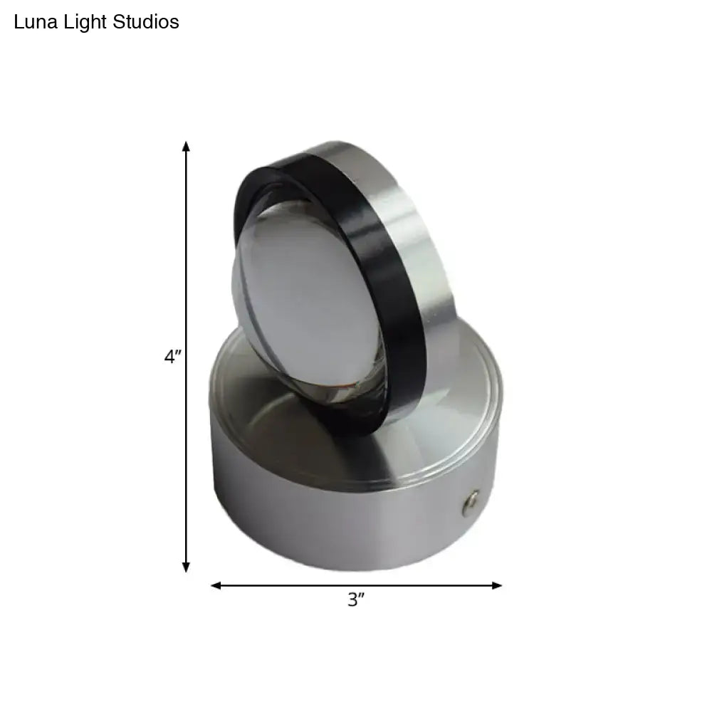 A sleek 4-inch tall stainless steel bedroom wall spotlight with silver finish and warm white lighting accents