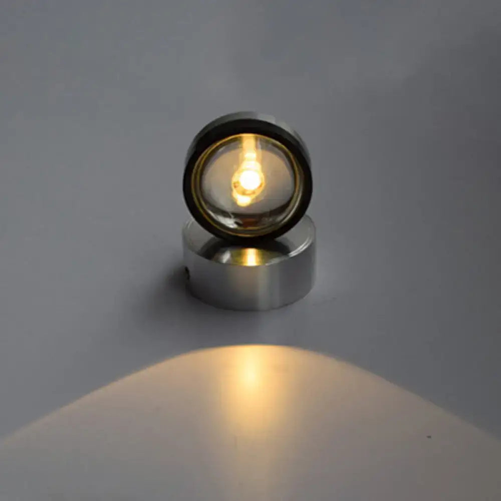 A sleek circular led spotlight with silver finish and warm white lighting ideal for bedroom wall illumination