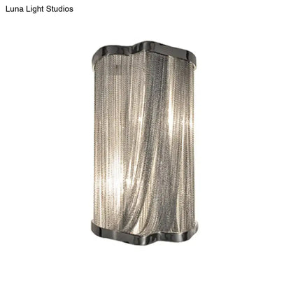 Modern silver finish wall mounted light with textured chain curtain and polished black metal frame for living room