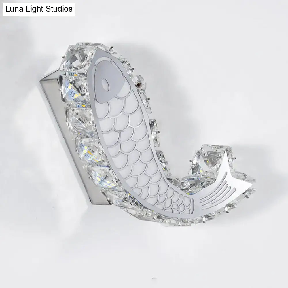 Modern silver fish wall sconce featuring a crystal block shade with clear crystals for bedroom lighting