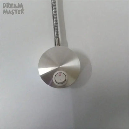 A sleek silver led wall lamp with a flexible metallic arm and adjustable knob for bedroom reading use