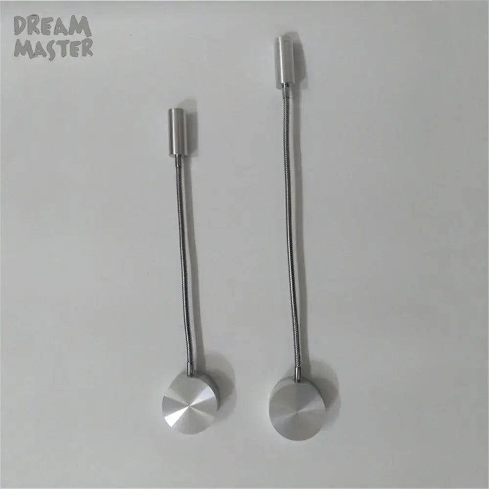 Two silver flexible led wall lamps with cylindrical heads and circular bases designed for bedroom reading use