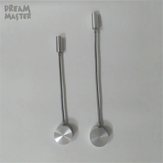 Two silver flexible led wall lamps with cylindrical heads and circular bases designed for bedroom reading use