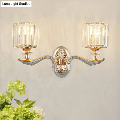 Elegant two-light flush mount wall sconce with clear crystal shade and silver-gold metallic finish for bedroom lighting