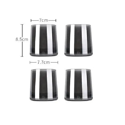 Set of four sleek dark gray glass tumblers with bold silver stripes for use with modern glass water pitcher