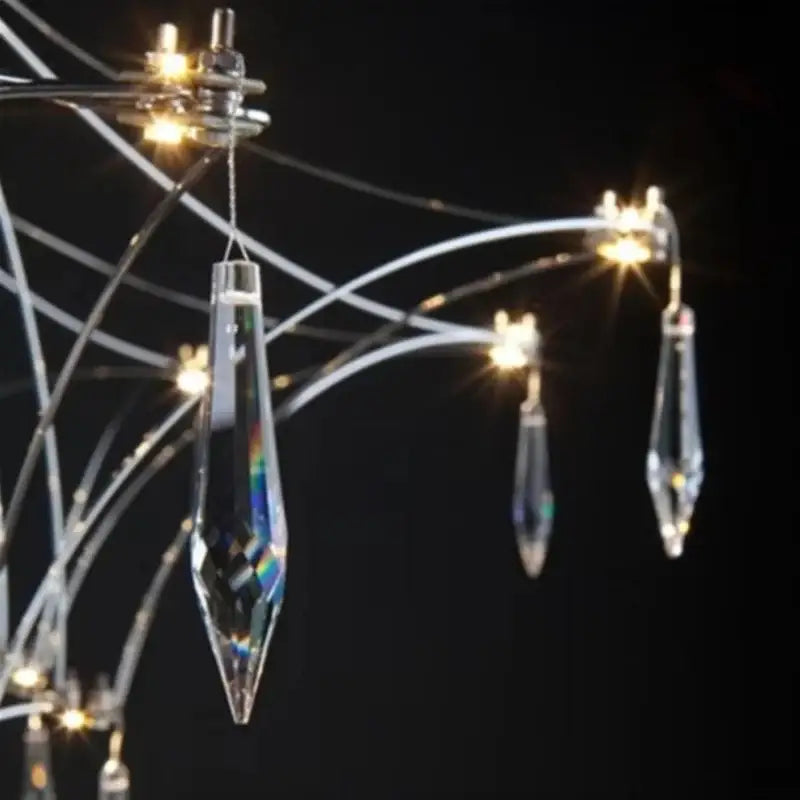 Modern silver and gold pendant light with clear crystal teardrop accents and chrome wire for a dining room focal point