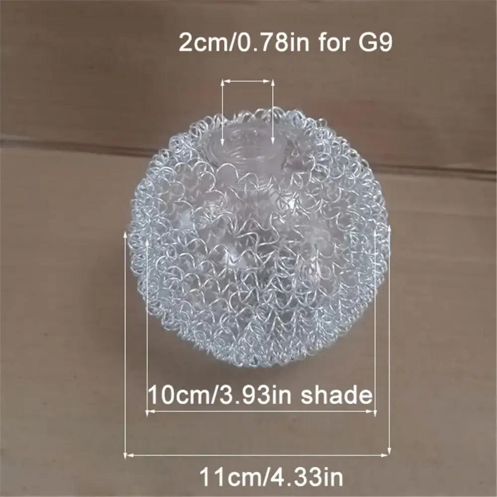 Transparent spherical stress ball with interwoven metallic wire texture resembling decorbites glass lampshade design