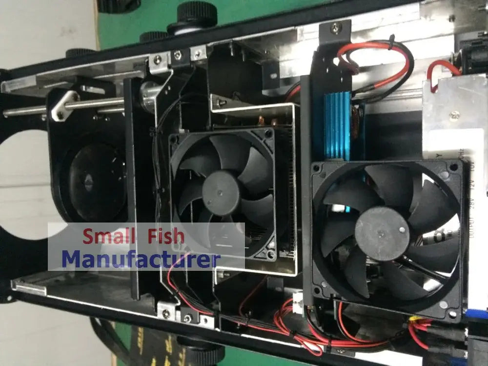 Black cooling fans with metallic frames mounted inside the back side of a modern silver metal 300w led follow spot light stage lighting