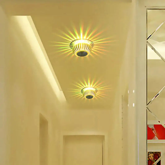 Two warm-toned direct wired silver starburst led sconces with metallic ribbed design for living room lighting