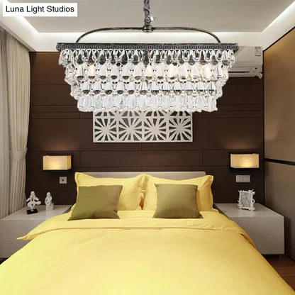 A sleek modern silver teardrop crystal ceiling light with dark metal frame for living room 220v-240v above bed